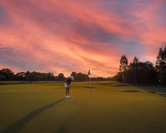 a woman playing golf at sunset Marrakech golf courses