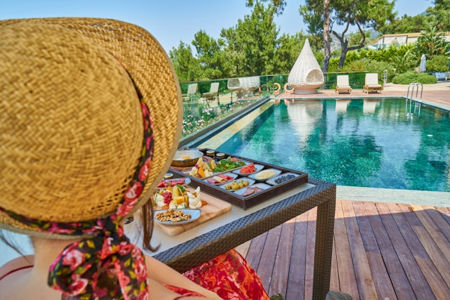Woman enjoying breakfast at a luxury hotel with elegant table setting and relaxing vacation atmosphere