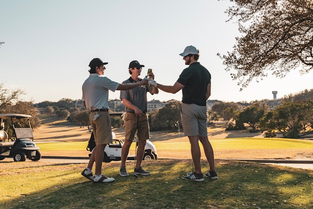 Friends enjoying a golf game together on a sunny golf course